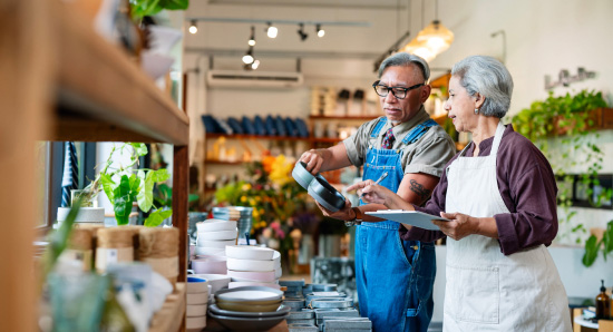 A store owner checking stock with their store manager.