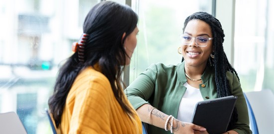 Female therapist listens attentively to young female