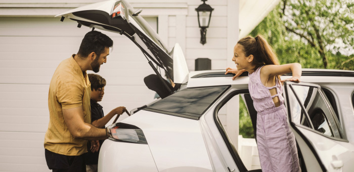 Family loading items into a vehicle