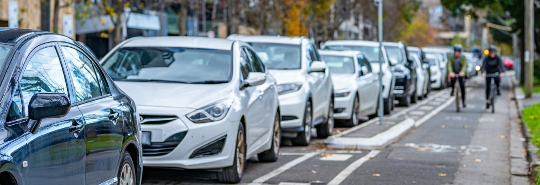 Cars parked along a busy urban street