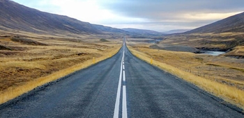 Long straight highway in rural mountainous setting