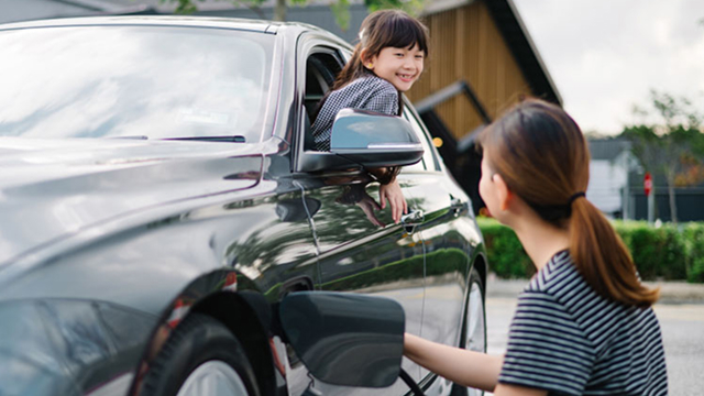 A mother and son charging an EV
