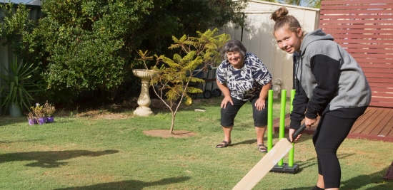 Illustration of people playing cricket in the backyard