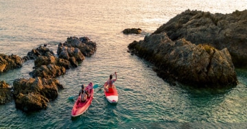 Image people paddling in canoes