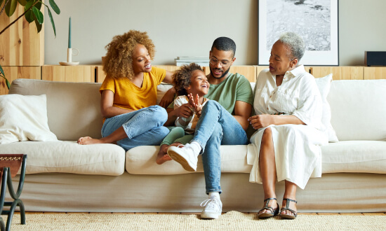 A happy family relaxing on the couch at home.