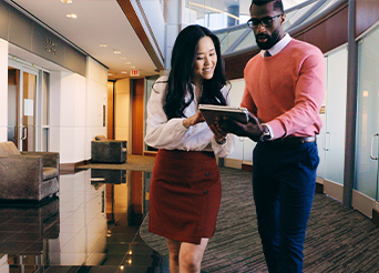 Man and a woman looking at a tablet screen together