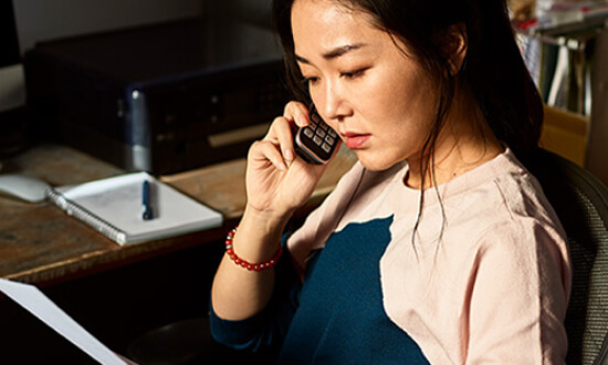 A woman on a mobile phone.